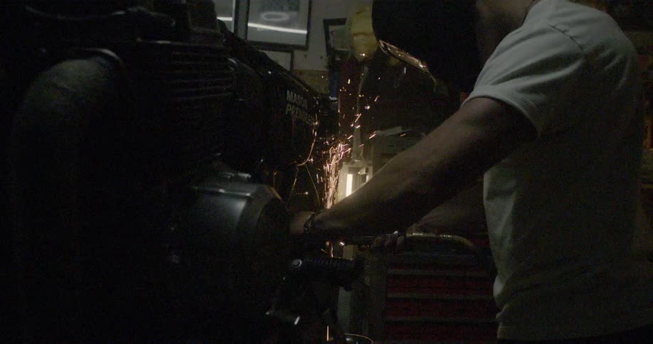 A man welds a large machine