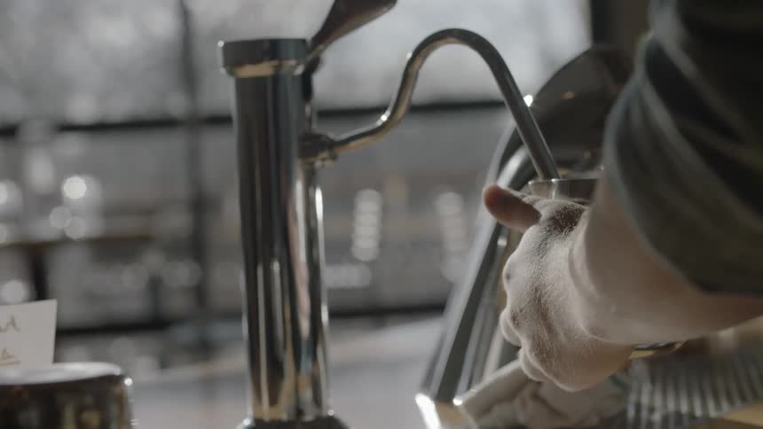 A man using a machine to pour a drink