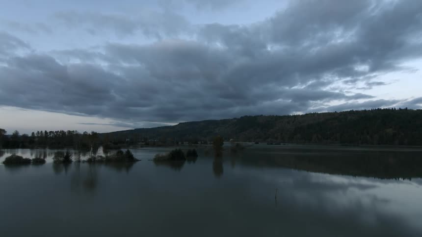 Flying over a lake towards the shore
