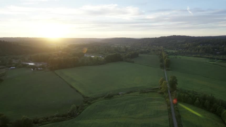 A farmland is shown at sunset