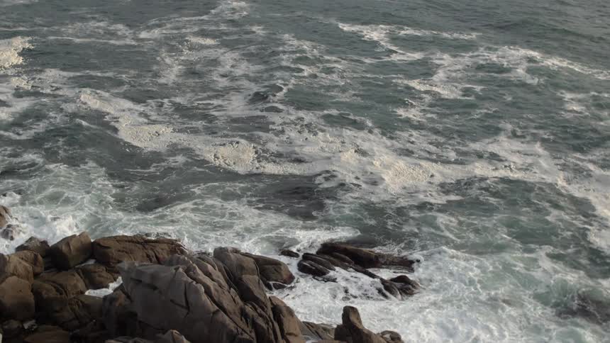 Waves crashing on rocky shore