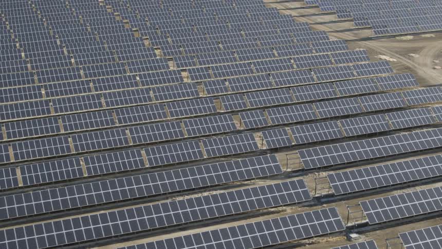 A large solar panel field on a bright day