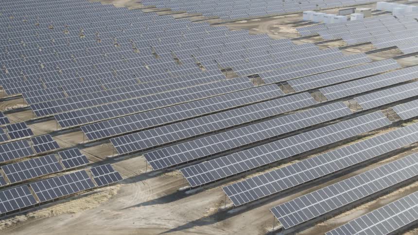 Slow pan over a solar panel farm