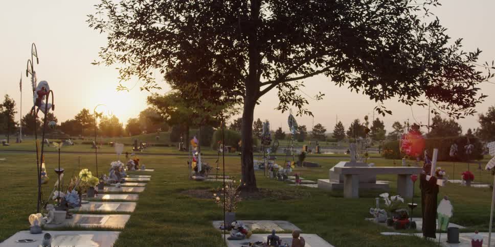 Cemetery with flowers on tombs while the sun rises