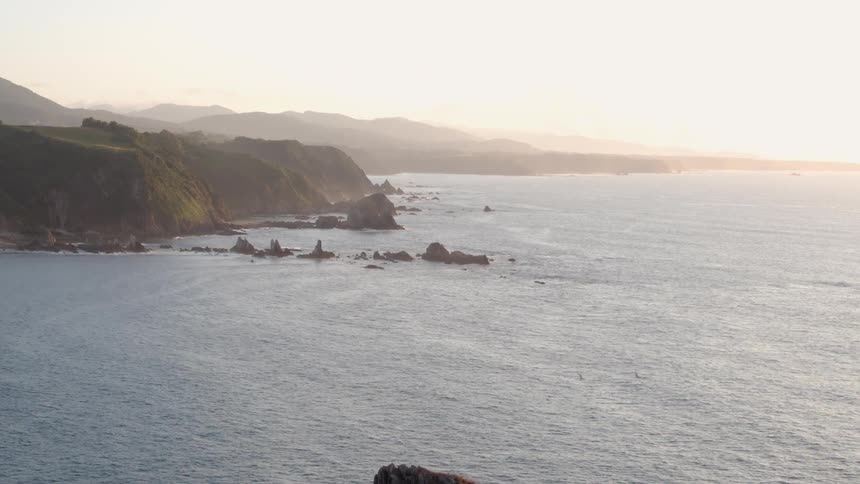 The sun sets on the horizon of the choppy cold water