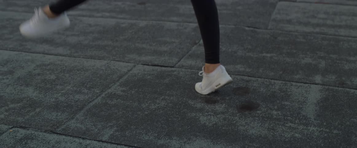 Woman dances on a rooftop at sunset
