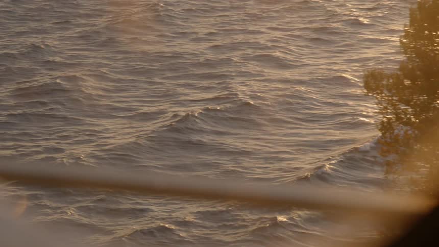 Waves are gently rolling in a body of water