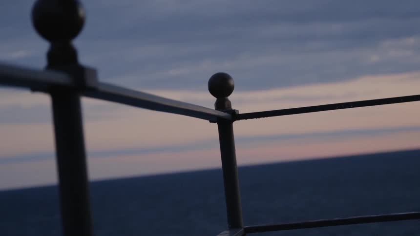 Looking at the sky and the sea through guardrails