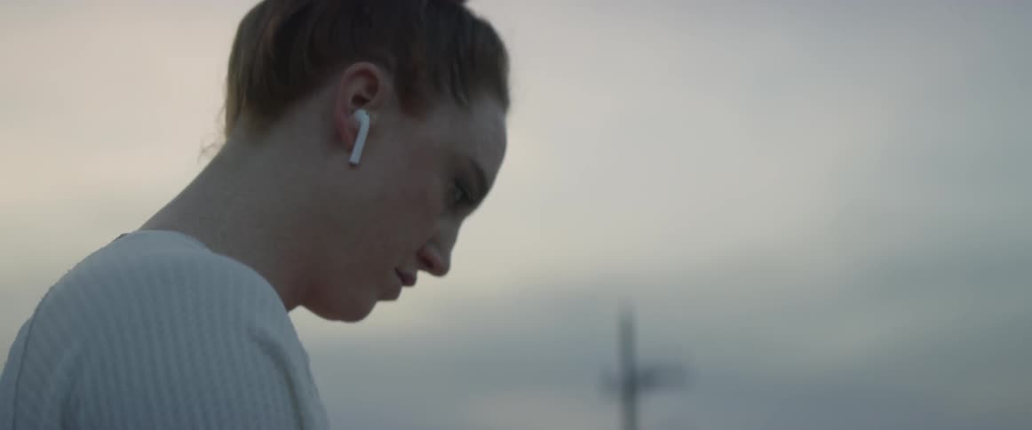 Woman with an ear bud in her ear