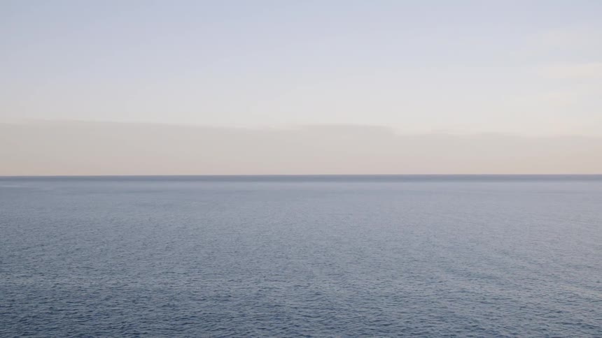 An ocean ripples in the sunset