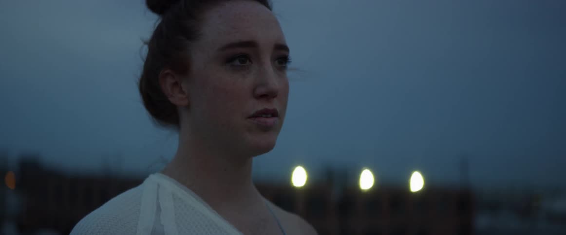 A woman takes a deep breath before turning to her left and starting to walk