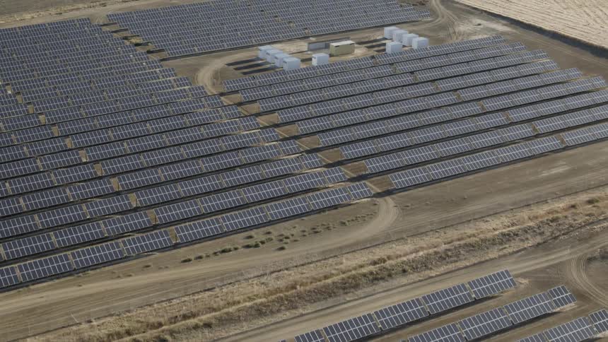 A field is filled with large solar panels