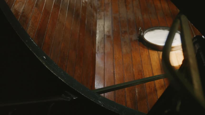 A spiral staircase with circular window
