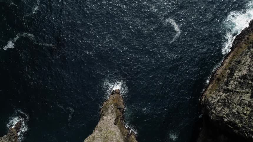 A lot of waves crashing against cliffs