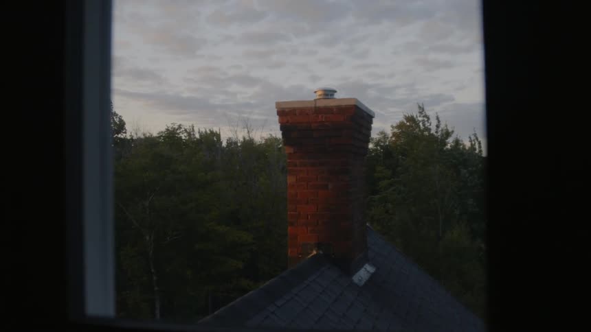 Looking through a window at a chimney