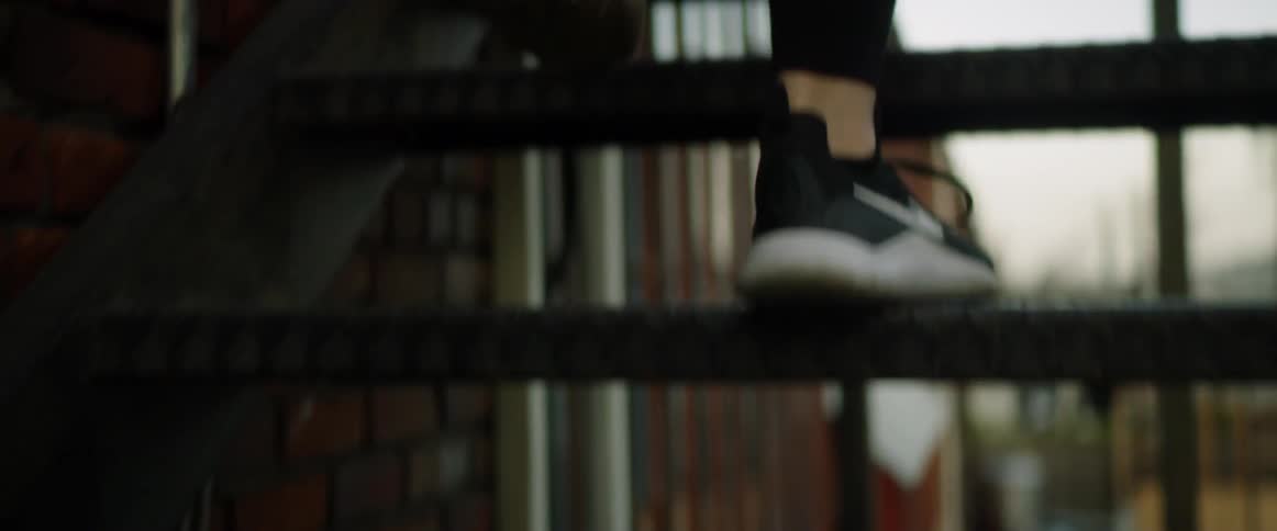 A person walking up exterior stairs