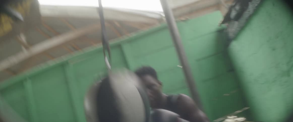 A man punching a basketball connected to a rope