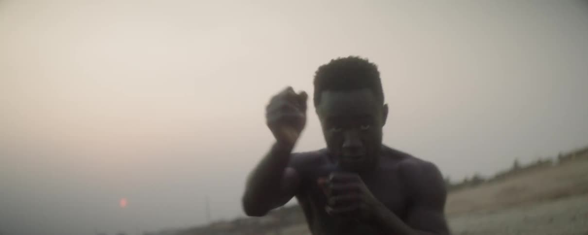 Man practicing his boxing on a beach