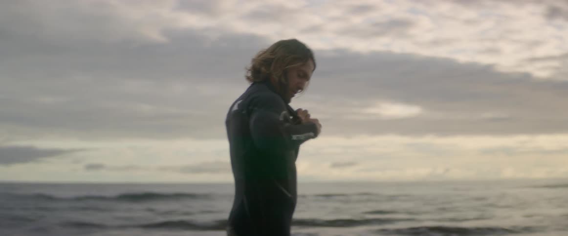 A man adjusts his wet suit