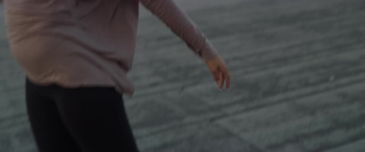 Woman dancing outside in an urban setting