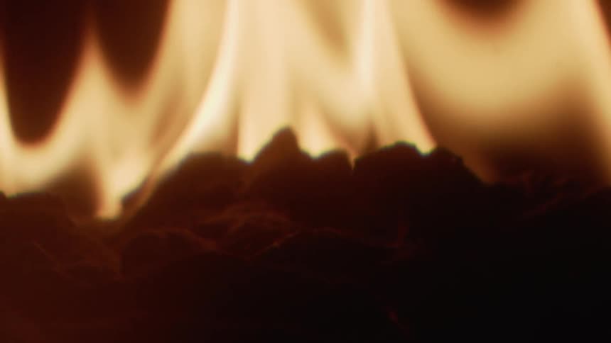 A fire burns in the night