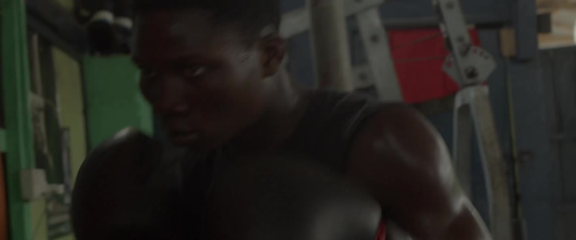 A man hitting a punching bag in a gym