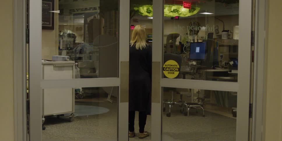 Doors close behind a woman in black standing inside a store