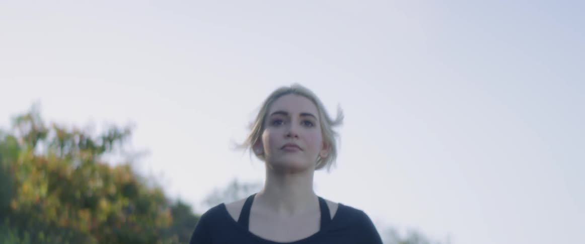 A woman jogging with trees in the background
