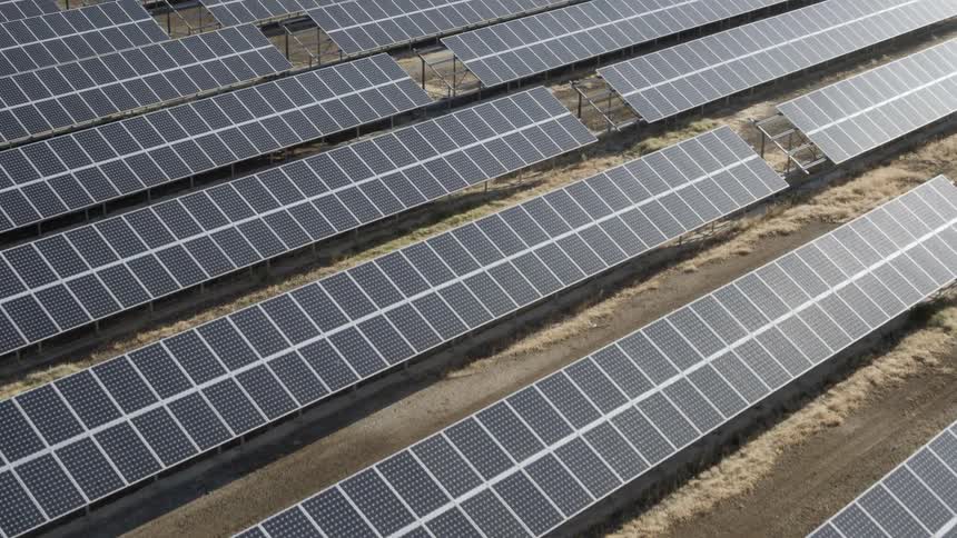 Neatly organized solar panels are illuminated by sunshine