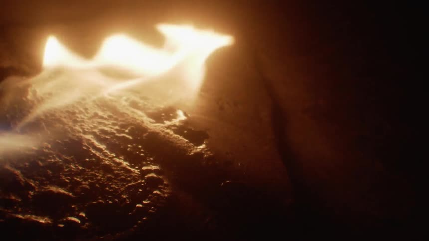 Flame burning on a surface that is wet and bubbly