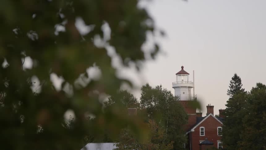 Looking at a lighthouse through the leaves of a tree