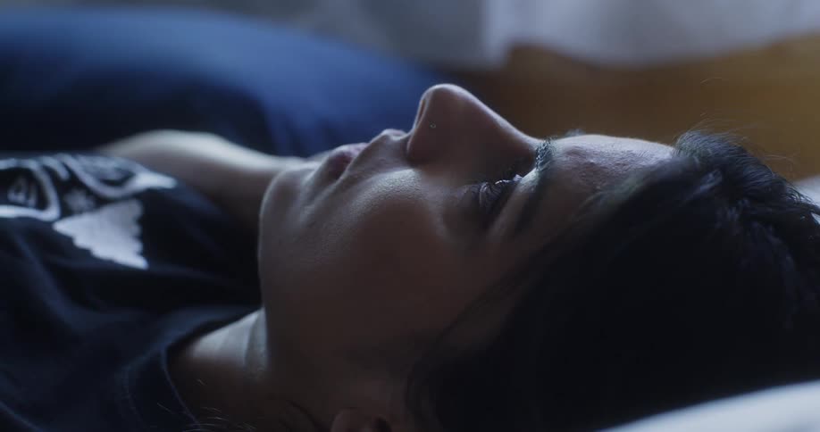 Woman lays on her back as she talks