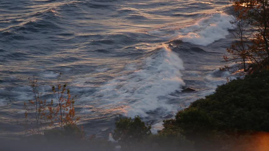 Looking at waves rocking around next to shore