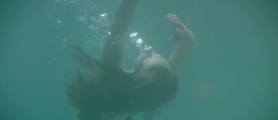A woman sinks into the water