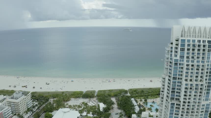 A city slides out of view as we move towards the ocean