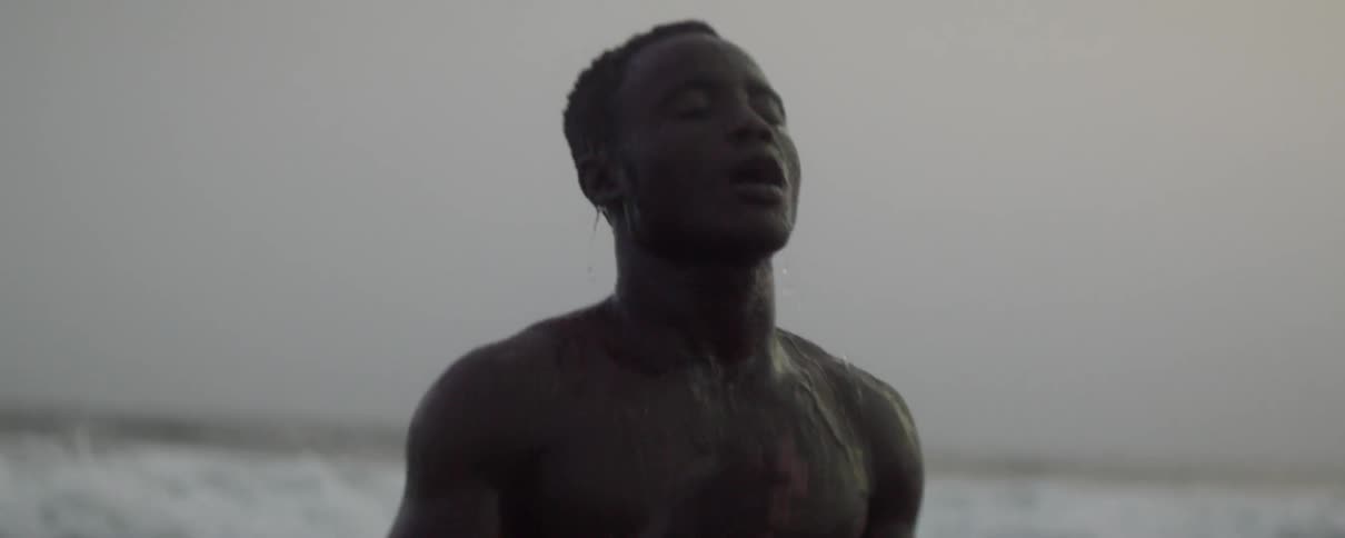 A man splashes his body in the ocean