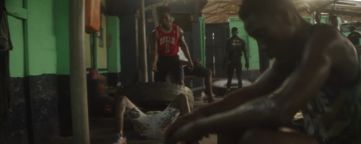 Men exercise in a gym with tires