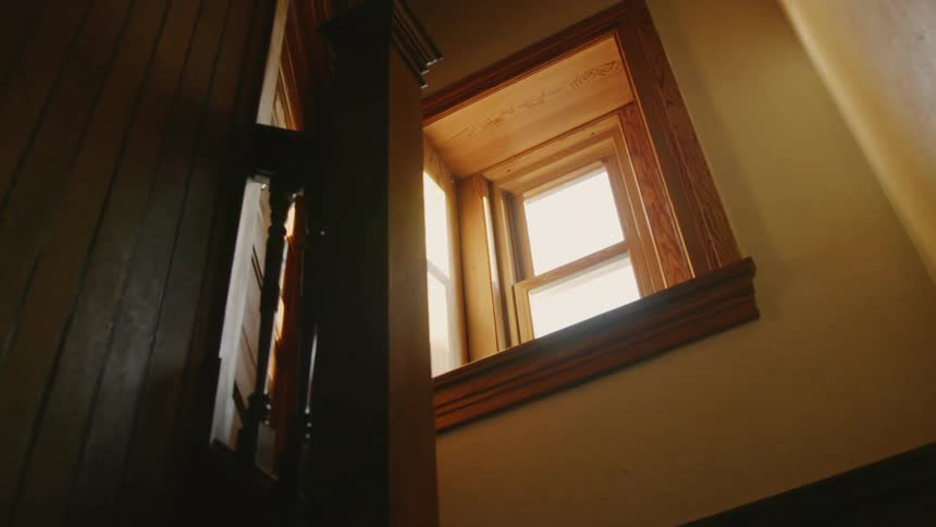 Going up the stairs of a house looking at the window
