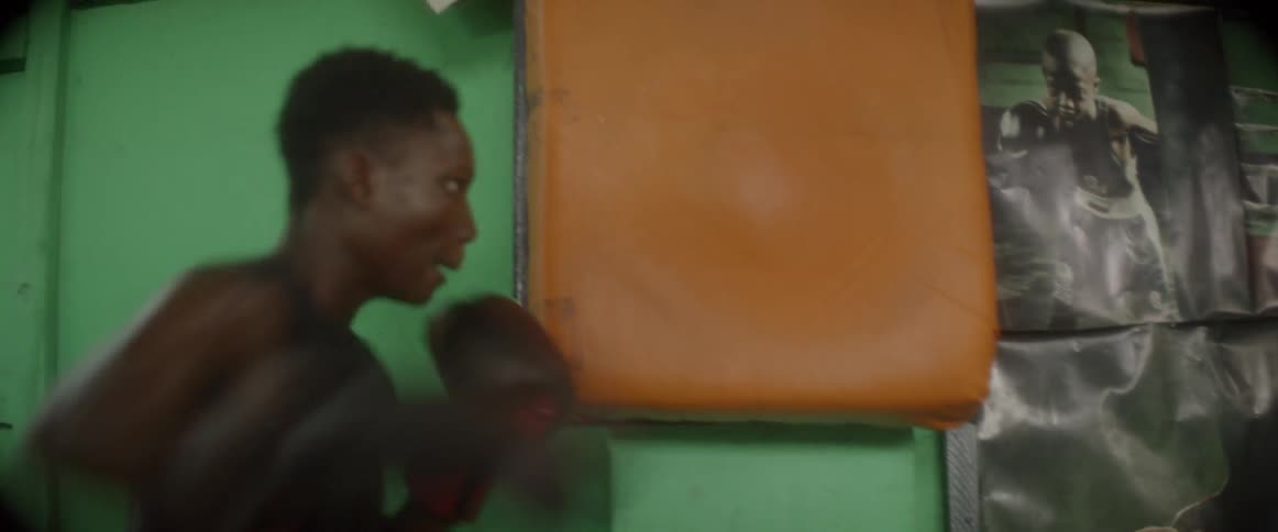 Man punches an orange mat on the wall