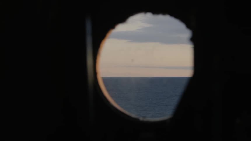 Looking at the sea through a ship window