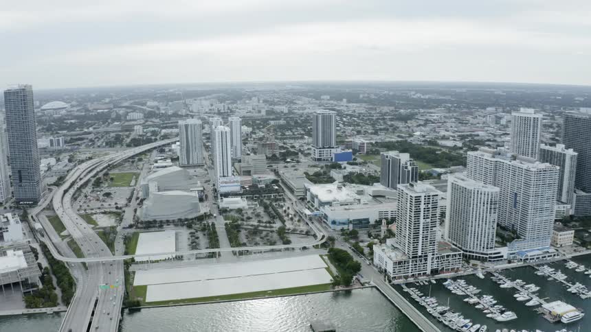 A view from a helicopter of a city that is next to the ocean