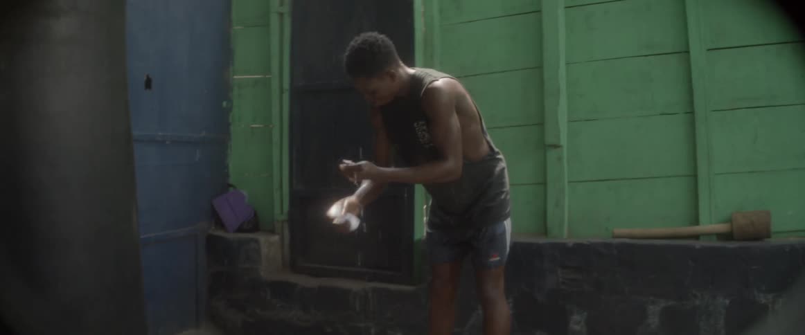 A male using a water from a drinking bottle to rinse his arm
