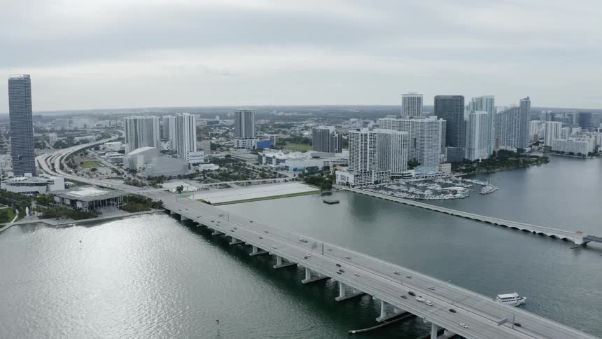 Aerial shot of city buildings bridge and water