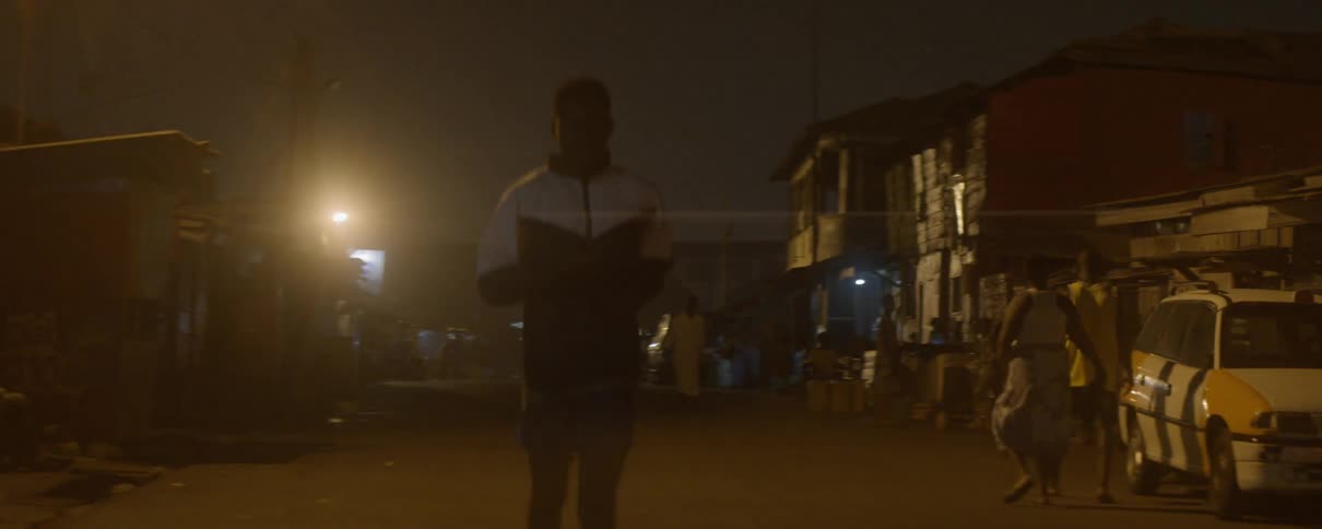 A man runs on the street at night