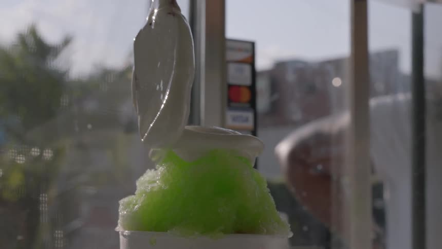Ice cream being swirled onto a green slush float