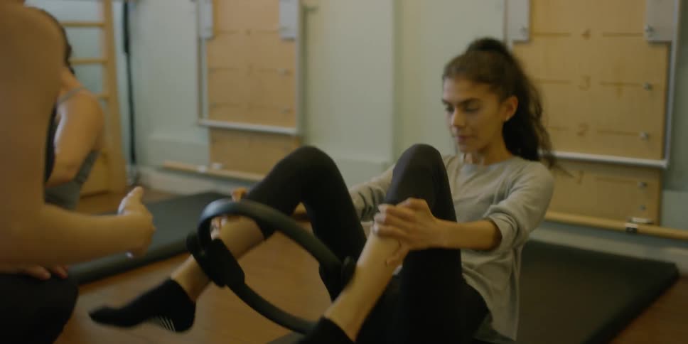 Woman Instructing Pilates Class