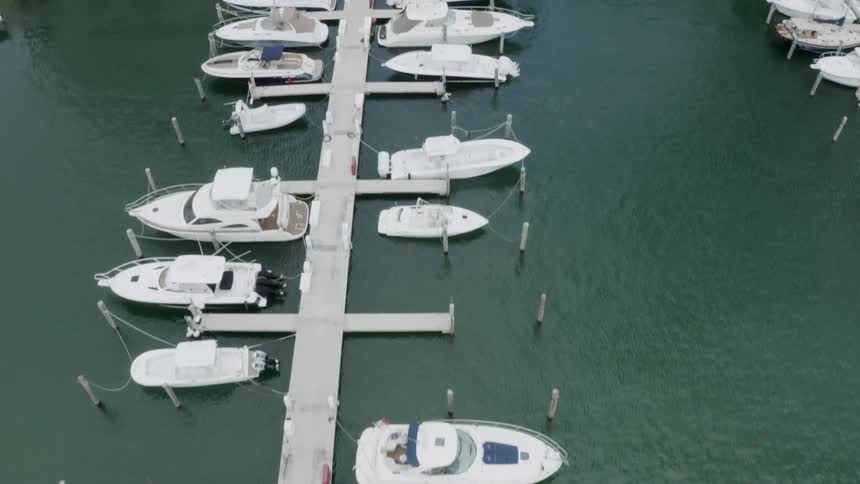 Small boats along a marina beside luxurious resorts