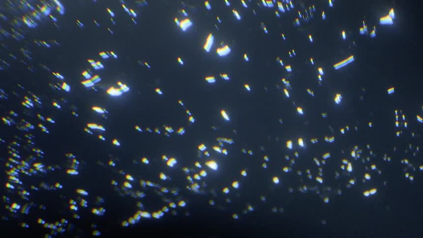 Specks of light shine in darkness