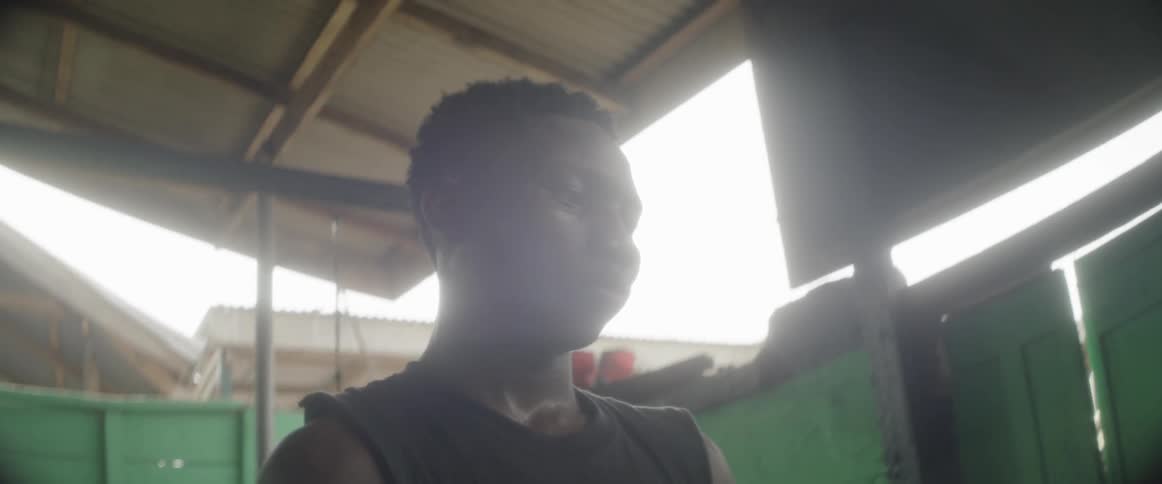 A man in gym clothes stares in thought