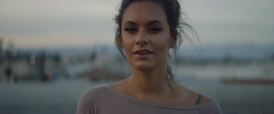 Smiling woman looking around at sunrise